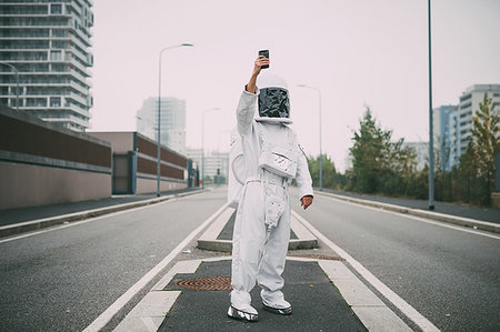 space suit - Astronaut taking selfie in middle of road Stock Photo - Premium Royalty-Free, Code: 649-09251041
