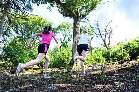 simsearch:649-07239413,k - Girlfriends running in forest, Tunbridge Wells, Kent, United Kingdom Stock Photo - Premium Royalty-Free, Code: 649-09251475