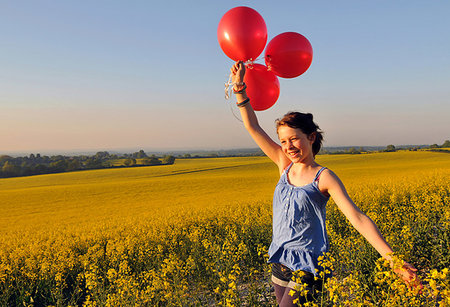 simsearch:649-07437432,k - Girl with red balloons on rapeseed field, Eastbourne, East Sussex, United Kingdom Stock Photo - Premium Royalty-Free, Code: 649-09251477