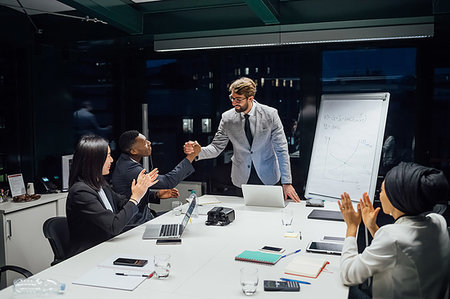 simsearch:649-07238396,k - Businessmen and women shaking hands and clapping at office presentation Stock Photo - Premium Royalty-Free, Code: 649-09251637