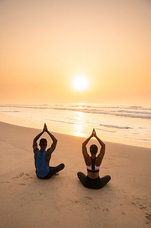 simsearch:649-07760822,k - Couple practising yoga on beach Stock Photo - Premium Royalty-Free, Code: 649-09251939