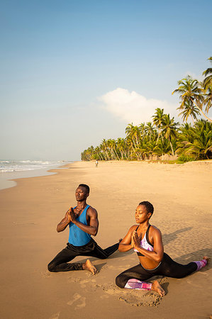 simsearch:649-07760822,k - Couple practising yoga on beach Stock Photo - Premium Royalty-Free, Code: 649-09251958