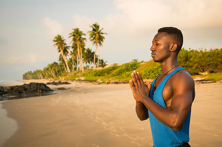 simsearch:693-05552857,k - Man practising yoga on beach Stock Photo - Premium Royalty-Free, Code: 649-09251950