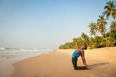 simsearch:693-05552857,k - Man practising yoga on beach Stock Photo - Premium Royalty-Free, Code: 649-09251966