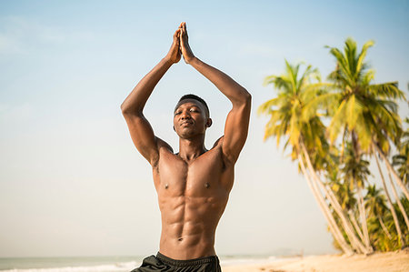 simsearch:693-05552857,k - Man practising yoga on beach Stock Photo - Premium Royalty-Free, Code: 649-09251984