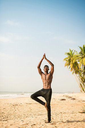 simsearch:649-07760822,k - Man practising yoga on beach Stock Photo - Premium Royalty-Free, Code: 649-09251985