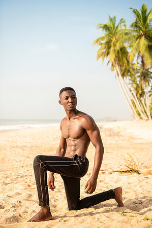 simsearch:693-05552857,k - Man practising yoga on beach Stock Photo - Premium Royalty-Free, Code: 649-09251983