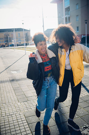 simsearch:649-07736862,k - Two cool young female friends laughing on urban sidewalk Stock Photo - Premium Royalty-Free, Code: 649-09268897