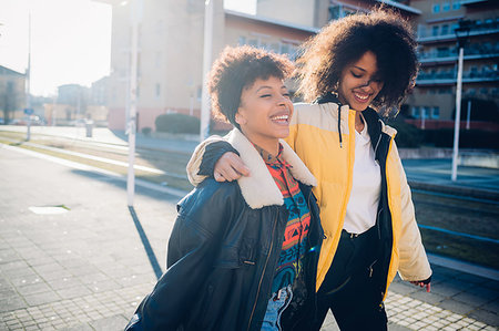 simsearch:649-07736862,k - Two cool young female friends strolling on sunlit urban sidewalk Stock Photo - Premium Royalty-Free, Code: 649-09268898