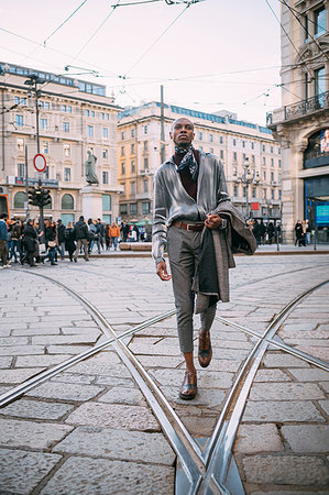 Stylish man walking over tram tracks in piazza, Milan, Italy Stock Photo - Premium Royalty-Free, Code: 649-09269233