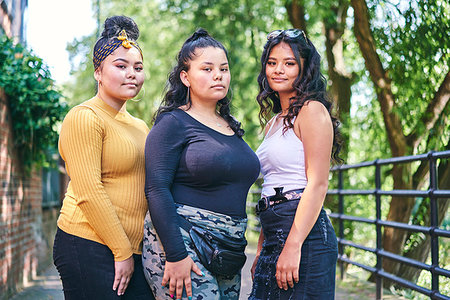 simsearch:649-07736862,k - Young woman posing with teenage sisters by park, portrait Stock Photo - Premium Royalty-Free, Code: 649-09275617