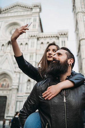 simsearch:649-08239088,k - Couple playing piggyback ride and taking selfie, Santa Maria del Fiore, Firenze, Toscana, Italy Stock Photo - Premium Royalty-Free, Code: 649-09276103