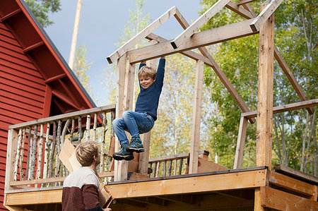 simsearch:649-08924209,k - Father watching boy swinging on beam of unfinished treehouse Stock Photo - Premium Royalty-Free, Code: 649-09277430