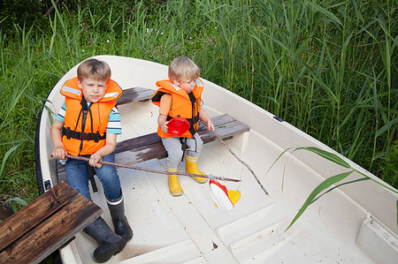 simsearch:649-06845253,k - Brothers playing on boat moored in grass field Stock Photo - Premium Royalty-Free, Code: 649-09277578