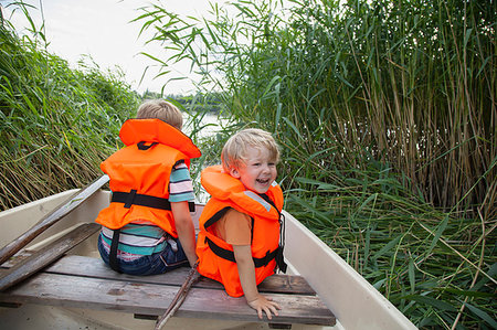 simsearch:649-07596731,k - Brothers playing on boat moored in grass field Stock Photo - Premium Royalty-Free, Code: 649-09277585