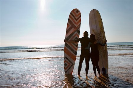 simsearch:649-01696405,k - Couple with surfboards standing on beach. Stock Photo - Premium Royalty-Free, Code: 649-01695900