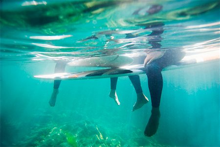 Couple's legs and surfboards underwater. Stock Photo - Premium Royalty-Free, Code: 649-01695917