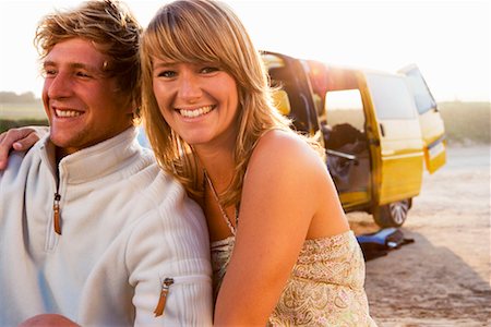 simsearch:649-01696405,k - Couple sitting on beach smiling with van in background. Stock Photo - Premium Royalty-Free, Code: 649-01695948