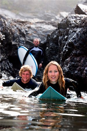 simsearch:649-01696405,k - Three people with surfboards smiling. Stock Photo - Premium Royalty-Free, Code: 649-01695981