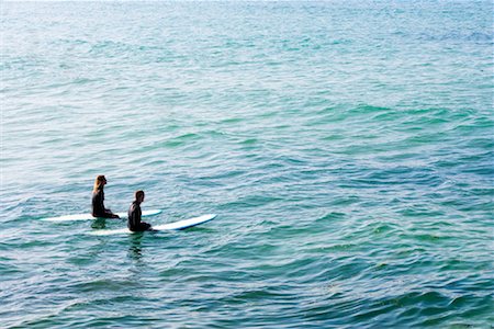 simsearch:649-01696405,k - Couple sitting on surfboards in the water. Stock Photo - Premium Royalty-Free, Code: 649-01696044