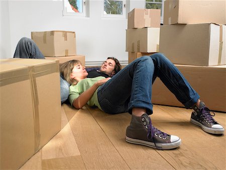 simsearch:649-01696405,k - Couple sleeping on floor with moving boxes around them. Stock Photo - Premium Royalty-Free, Code: 649-01696483