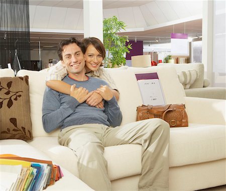 furniture store - Smiling couple on sofa in furniture shop. Stock Photo - Premium Royalty-Free, Code: 649-01755147