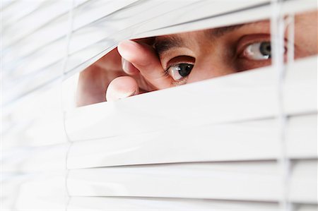 spying - Man looking through office blinds Stock Photo - Premium Royalty-Free, Code: 649-02055353