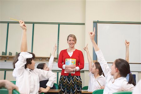 simsearch:649-07280058,k - Children raising hands in classroom Stock Photo - Premium Royalty-Free, Code: 649-02055474