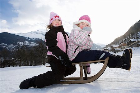 Girls towed on sledge in snow Stock Photo - Premium Royalty-Free, Code: 649-02053549