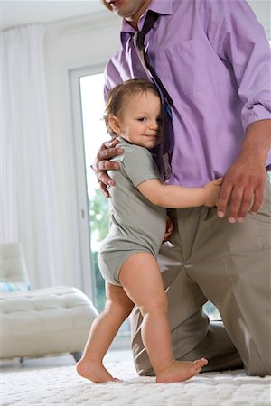 simsearch:632-08001820,k - Baby hugs fathers legs and smiles Stock Photo - Premium Royalty-Free, Code: 649-02198792