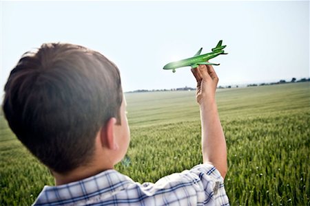 solution concept - Boy playing with toy plane Stock Photo - Premium Royalty-Free, Code: 649-02198915