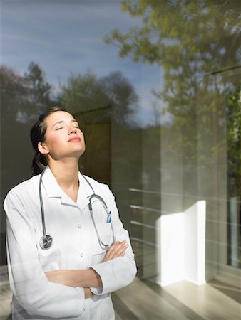 Young female doctor by the window Stock Photo - Premium Royalty-Free, Code: 649-02199151