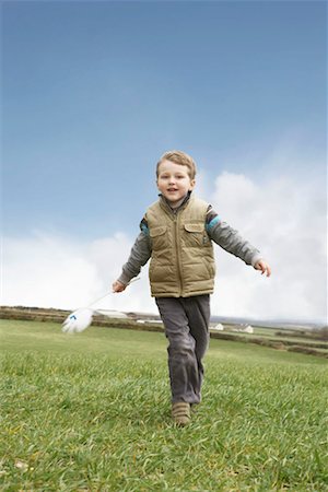 simsearch:649-06352471,k - Boy running with windmill Stock Photo - Premium Royalty-Free, Code: 649-02199588