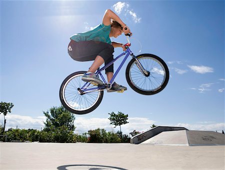 Teen boy on bike jumping Stock Photo - Premium Royalty-Free, Code: 649-02290293