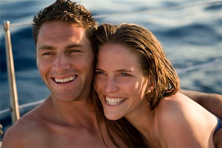 simsearch:649-05520995,k - Couple smiling on boat at sea Stock Photo - Premium Royalty-Free, Code: 649-02290388