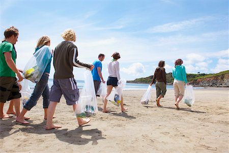 environmental impact - Young people collecting garbage on beach Stock Photo - Premium Royalty-Free, Code: 649-02290477