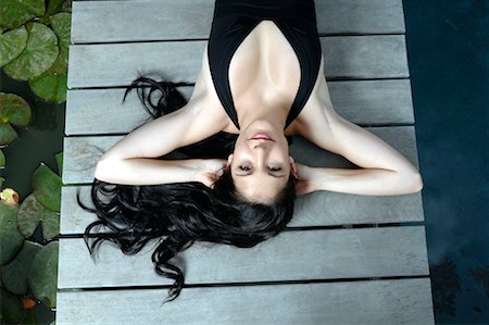 sexual pleasure - Woman lying down on wooden deck Stock Photo - Premium Royalty-Free, Code: 649-02290793