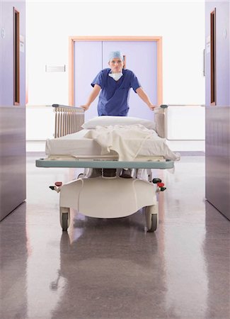 A female doctor pushing a bed Stock Photo - Premium Royalty-Free, Code: 649-02666331
