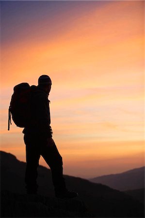 silhouette person outdoors mountains - Hiker looking at the sunrise. Stock Photo - Premium Royalty-Free, Code: 649-02666923