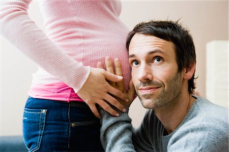 simsearch:649-03447245,k - Man listening at wife's pregnant stomach Stock Photo - Premium Royalty-Free, Code: 649-02731296