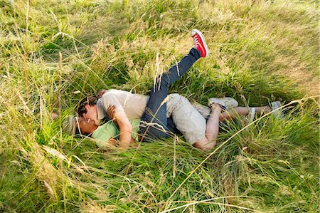 simsearch:649-01696405,k - Couple fooling around in a field Stock Photo - Premium Royalty-Free, Code: 649-02731835