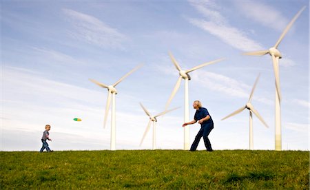 simsearch:6113-07589515,k - Man,  boy play Frisbee at Wind Turbines Stock Photo - Premium Royalty-Free, Code: 649-02732170