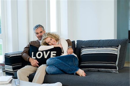 simsearch:649-06716867,k - Man and woman on sofa with cushion Stock Photo - Premium Royalty-Free, Code: 649-02732361