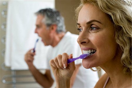 Man and woman brushing teeth Stock Photo - Premium Royalty-Free, Code: 649-02732371