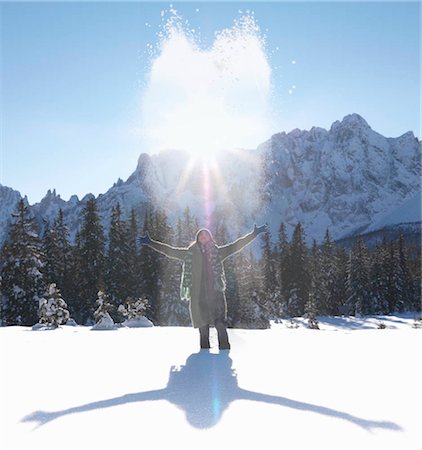 simsearch:649-03857163,k - Woman throwing snow up into the air Stock Photo - Premium Royalty-Free, Code: 649-02732769