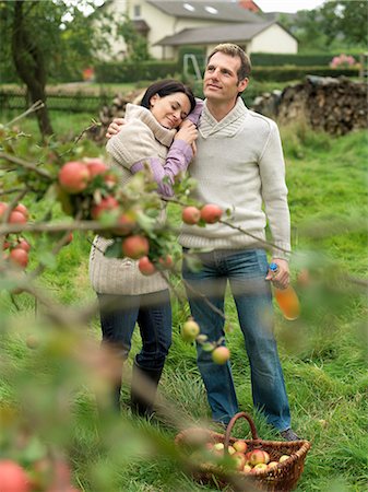 Man and woman picking apples cuddling Stock Photo - Premium Royalty-Free, Code: 649-03008694