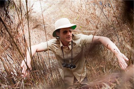 explorer - man in jungle outfit wading riverside Stock Photo - Premium Royalty-Free, Code: 649-03008917