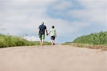 road together - Father and son walking up a road Stock Photo - Premium Royalty-Free, Code: 649-03077799
