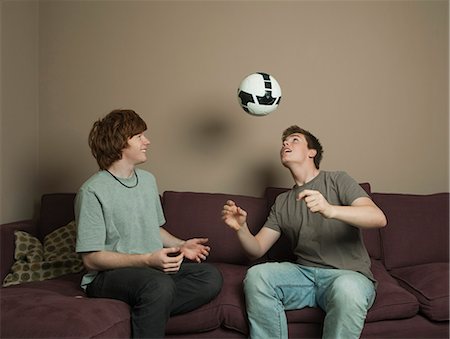 friends playing football - Boys playing football indoors Stock Photo - Premium Royalty-Free, Code: 649-03077864