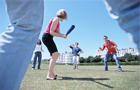 A group playing baseball in a park Stock Photo - Premium Royalty-Free, Code: 649-03078685
